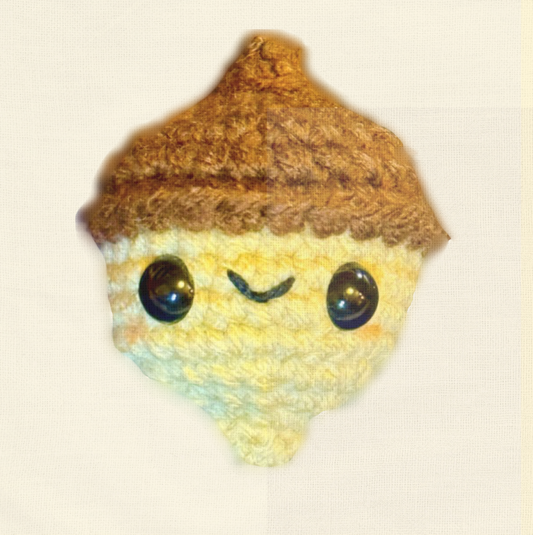 Augie the Acorn, a handmade catnip toy from Feline Grove’s Chunkle Puff collection, shown alone on a neutral background. Woven acorn form highlights artisanal detail, autumn harvest style, and luxury craftsmanship.