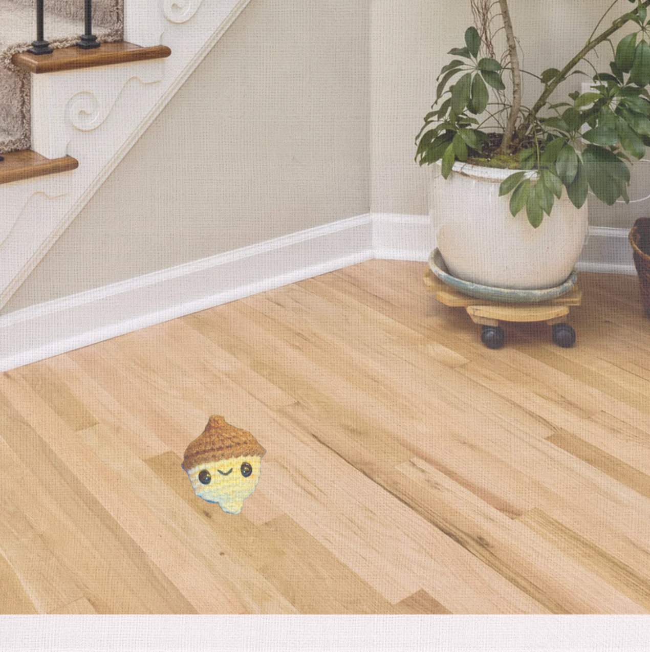 Lifestyle photo of Augie the Acorn, a handmade Chunkle Puff catnip toy by Feline Grove. Shown in a refined interior with linen backdrop, presenting his acorn design as a luxury harvest-inspired piece for elegant homes.
