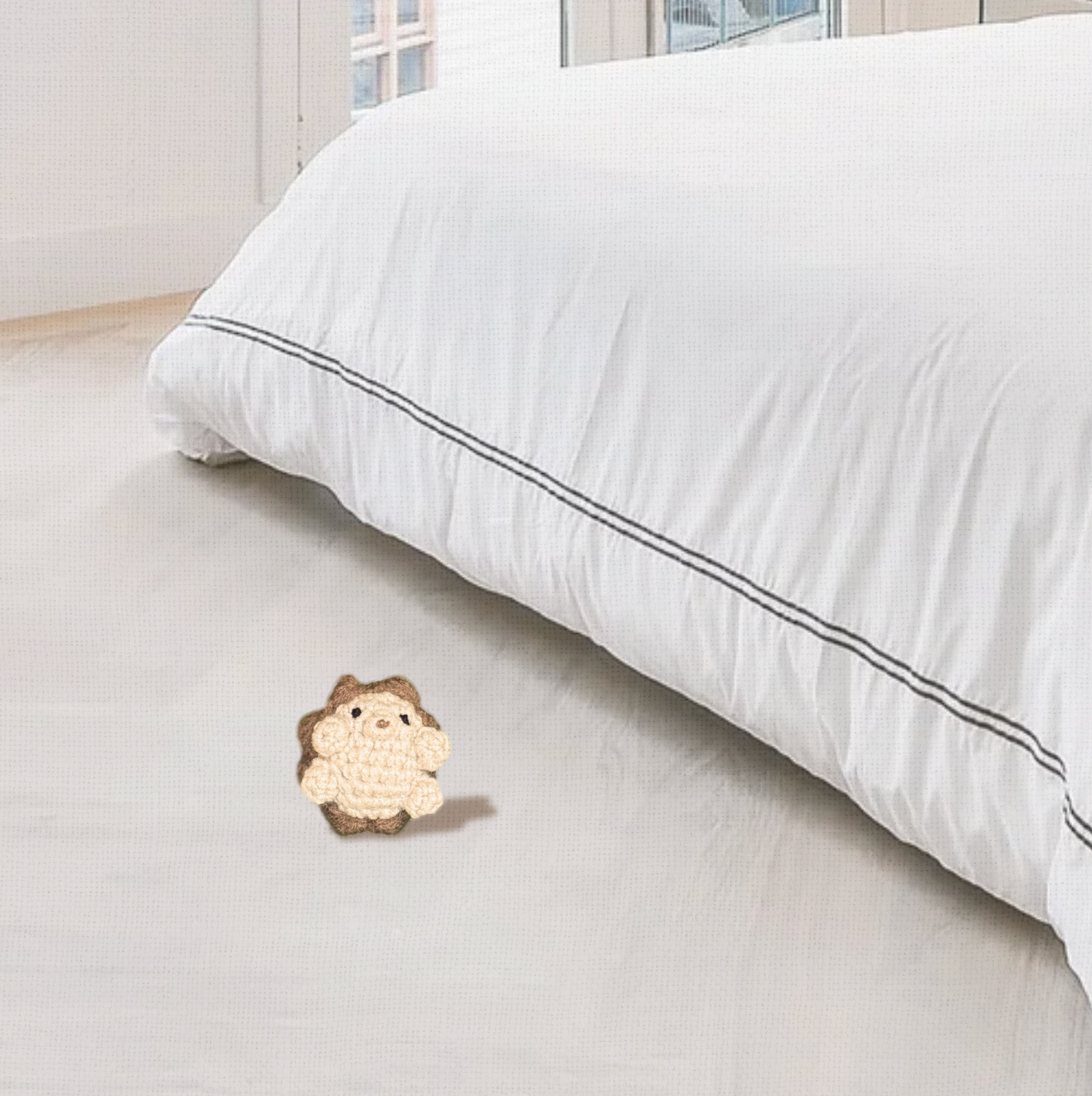 Lifestyle photo of Harold the Hedgehog, a handmade Chunkle Puff catnip toy by Feline Grove. Shown in a refined interior with soft linen backdrop, presenting his woodland hedgehog design as a luxury play piece.