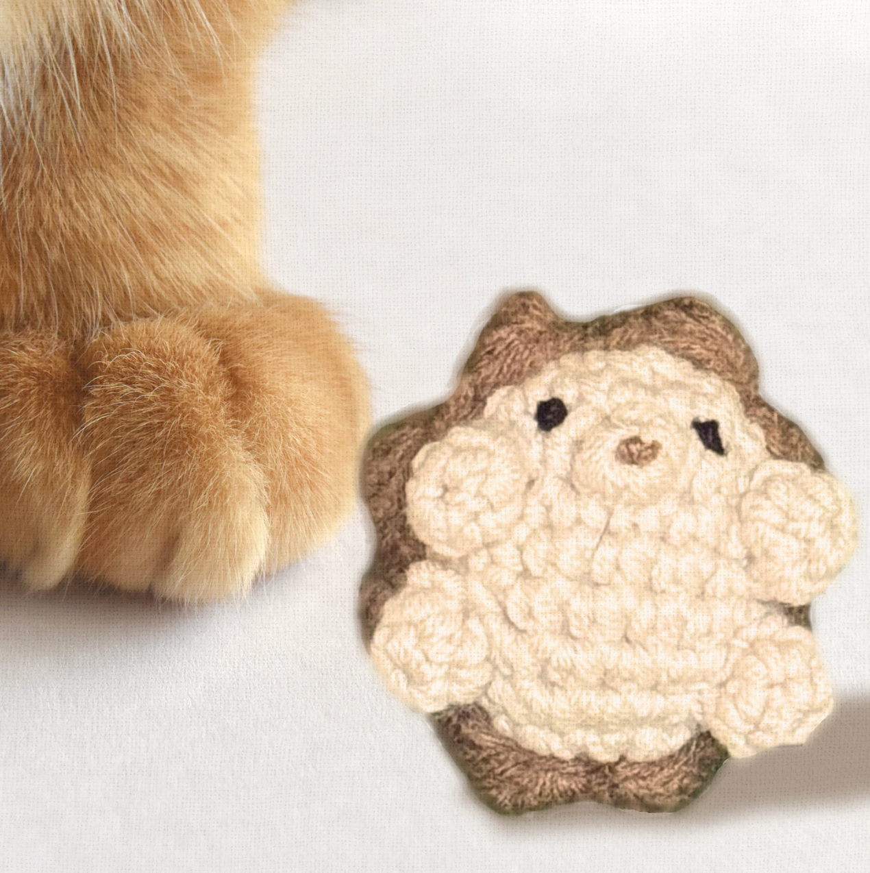 Harold the Hedgehog, a handmade Chunkle Puff catnip toy measuring approx. 2 inches, shown beside a familiar object for scale. His woven hedgehog form highlights his playful small size and boutique detail.