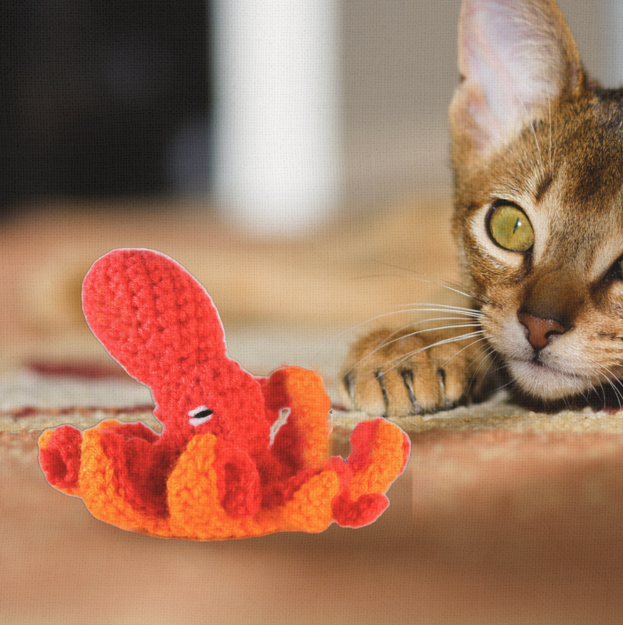 Cat playing with Julie the Kraken, a handmade Chunkle Puff catnip toy from Feline Grove. The 6-inch woven octopus toy is batted and tugged by tentacles, demonstrating playful motion and irresistible botanicals.