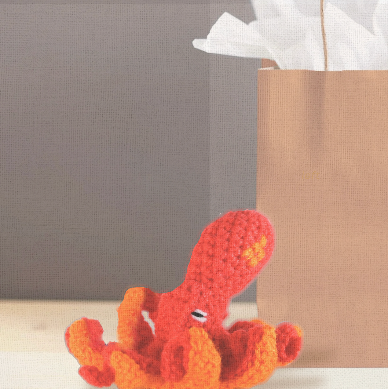 Julie the Kraken, a handmade Chunkle Puff catnip toy by Feline Grove, shown with her boutique gift bag. The 6-inch woven octopus toy is presented as a luxury piece designed for gifting and refined play.