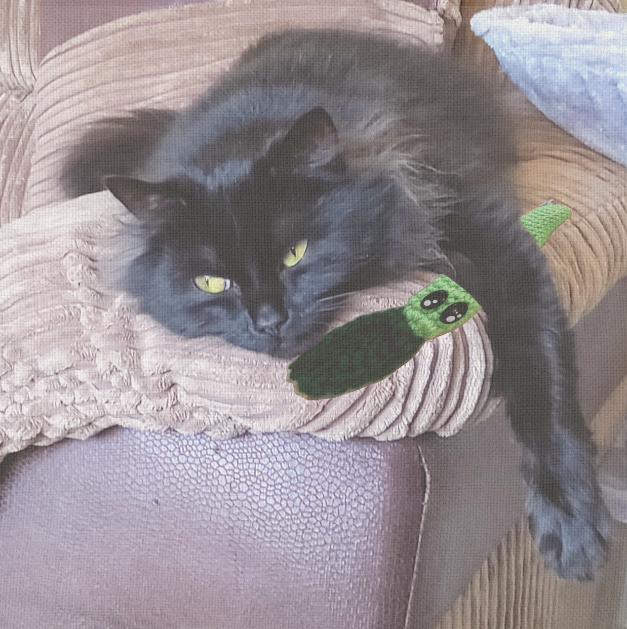 Cat lounging with Leaf Stick, a handmade Chunkle Puff catnip toy by Feline Grove. The woven leaf toy rests beside the cat, emphasizing softness, crinkle appeal, and boutique design.