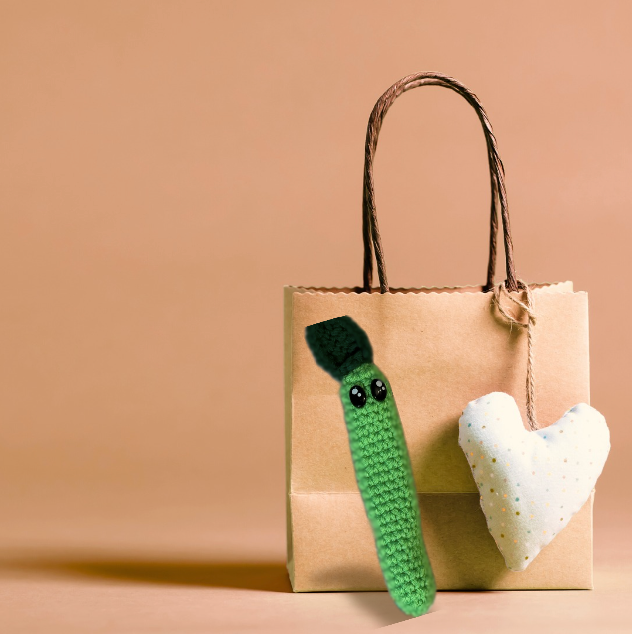 Leaf Stick, a handmade Chunkle Puff catnip toy by Feline Grove, shown with her boutique gift bag. The crinkle-filled woven leaf toy is presented as a luxury piece designed for gifting and refined play.