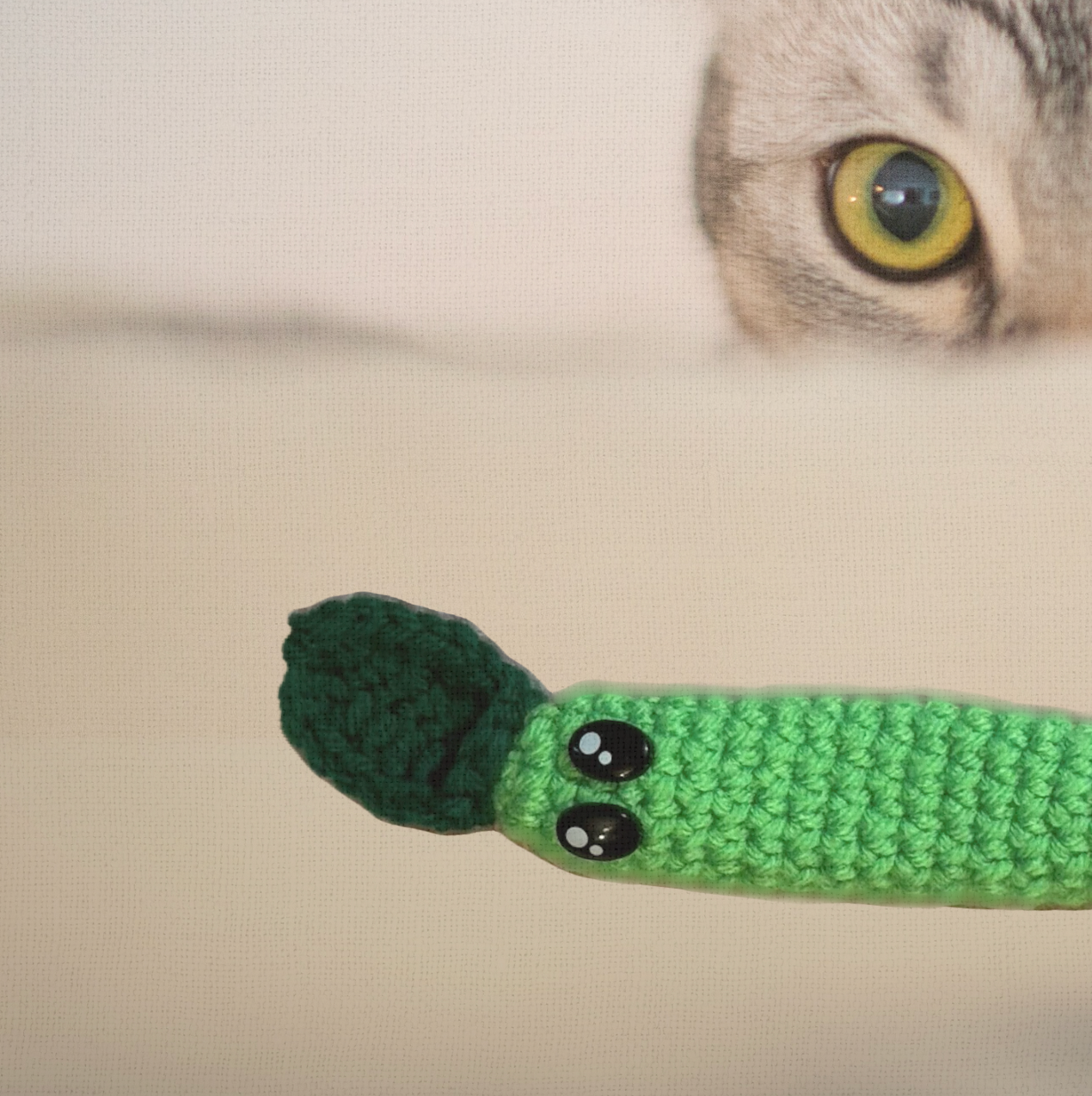 Leaf Stick, a handmade Chunkle Puff catnip toy measuring several inches long, shown beside a familiar object for scale. The crinkle-filled woven leaf form highlights her playful size and tossable shape.
