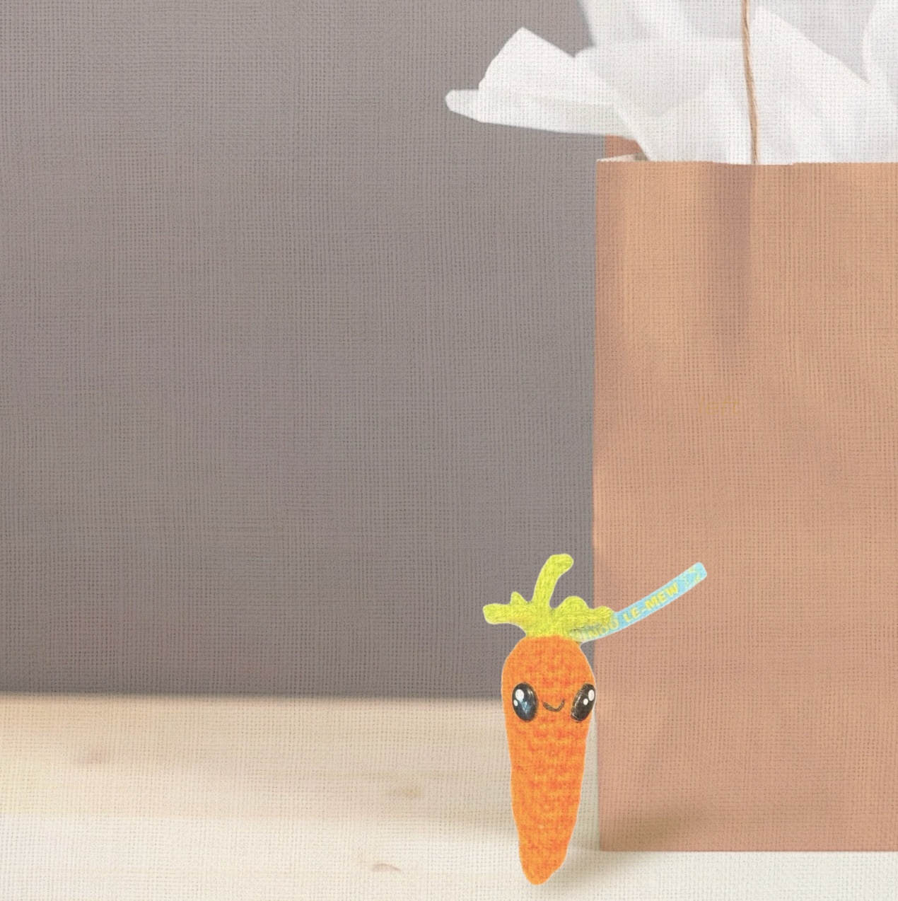 Lulu the Carrot, a handmade Chunkle Puff catnip toy by Feline Grove, shown with her boutique gift bag. The 3.5-inch woven carrot toy is presented as a luxury piece designed for gifting and refined play.