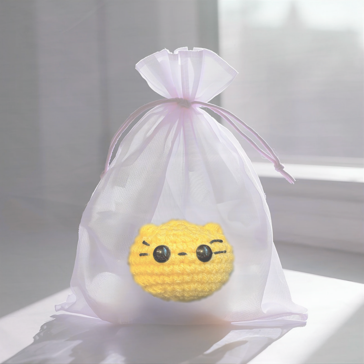 Pippa the Chonk, a handmade weighted Chunkle Chunk catnip toy by Feline Grove, shown with her boutique gift bag. The round weighted toy is presented as a luxury collectible piece designed for refined play and gifting.