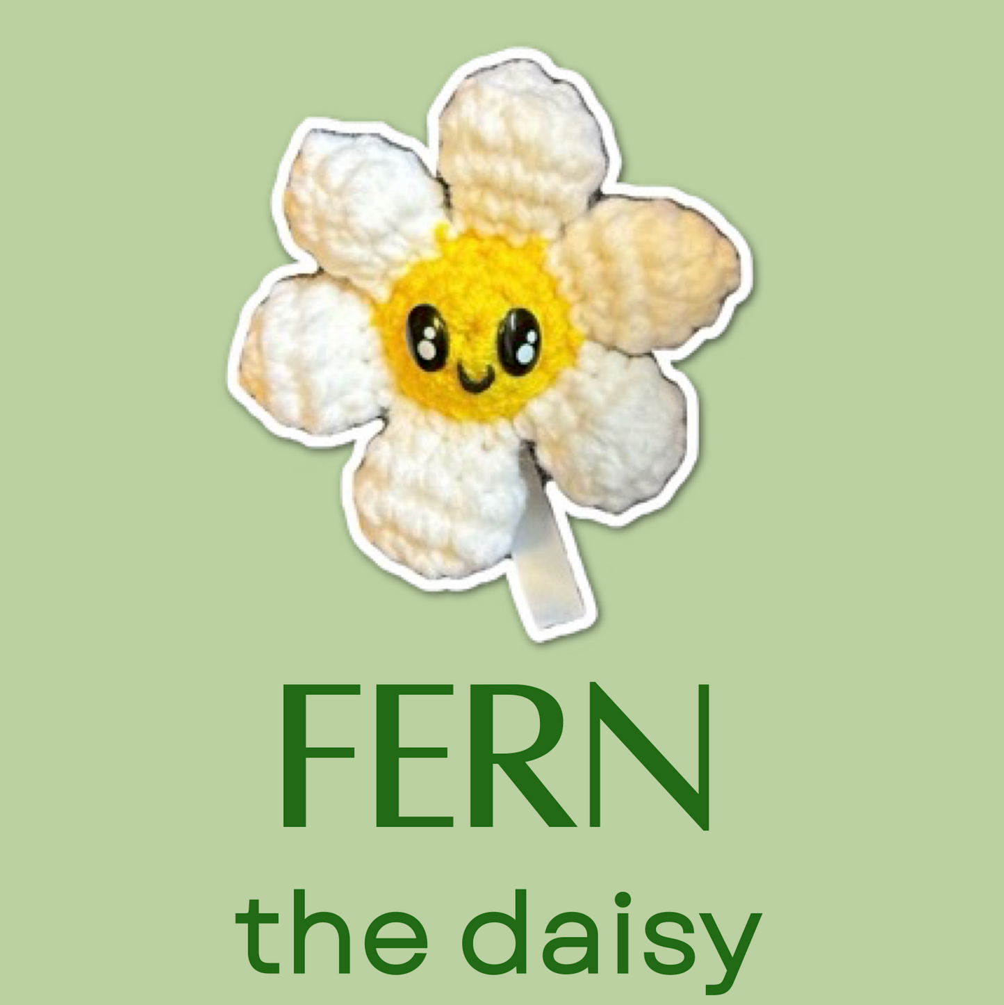 Plush toy of a daisy with a smiling face on a green background, labeled 'Fern the Daisy'.