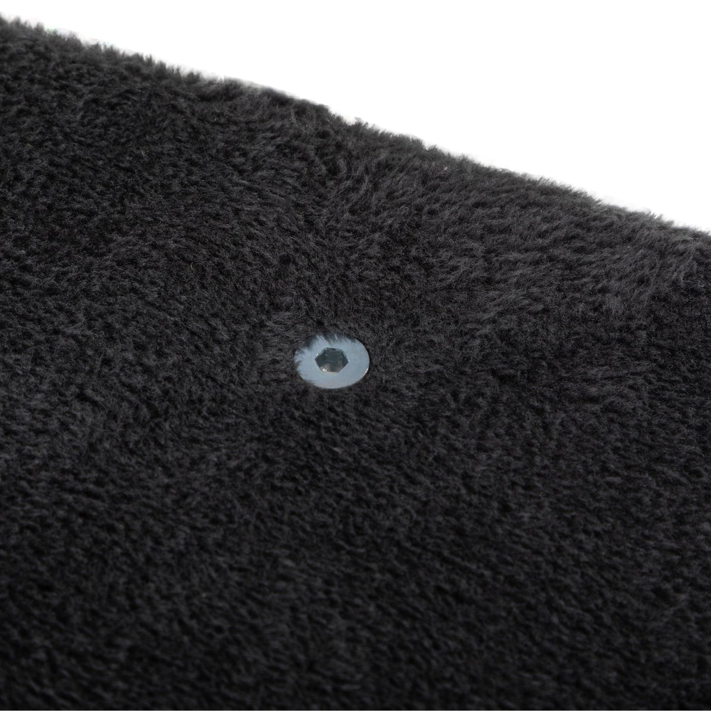 Close-up of a pre-drilled hardware insert nestled into plush charcoal-grey fabric, showing the refined construction and soft texture of The Grove Set’s mounting components.
