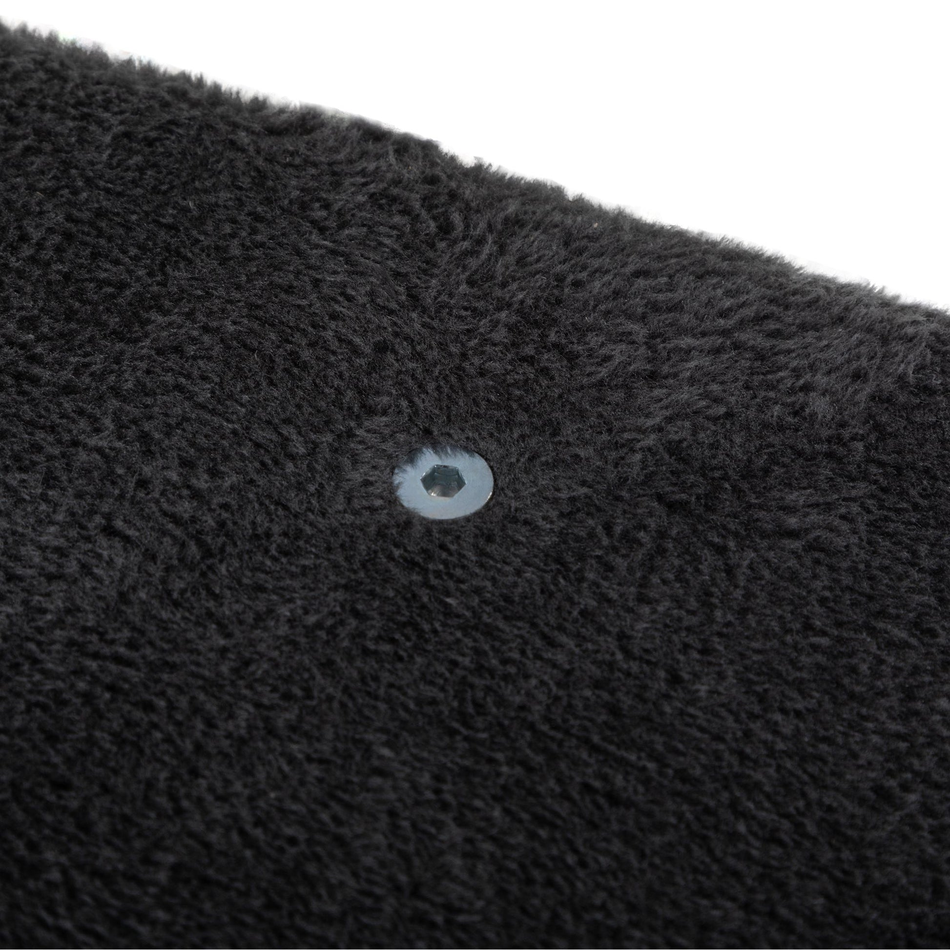 Close-up of a pre-drilled hardware insert nestled into plush charcoal-grey fabric, showing the refined construction and soft texture of The Grove Set’s mounting components.