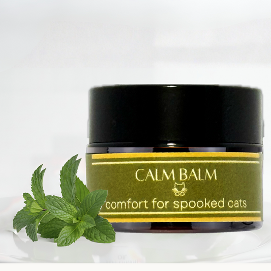 Feline Grove's Calm Balm jar with a label and catnip leaves on a white background