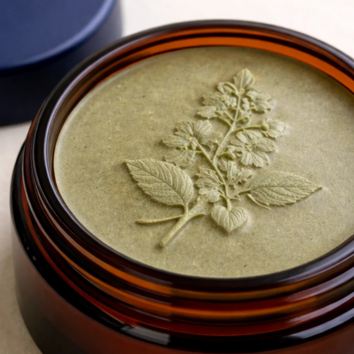 Feline Grove's calm balm in jar with leaf design in it's amber glass jar container